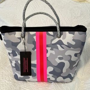 Haute Shore Neoprene handbag with small bag and adjustable shoulder strap.